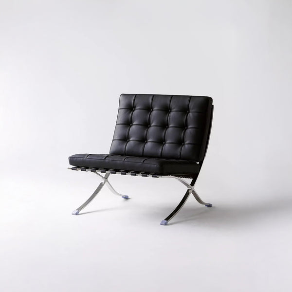 Fauteuil Lounge & Repose-Pieds – Cuir Véritable Noir et Structure Chromée Sculpturale